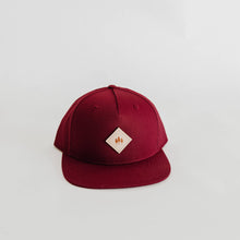 Load image into Gallery viewer, Red hat with leather diamond patch featuring three trees