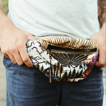 Load image into Gallery viewer, atomicchild fanny pack with clouds, trees, mountains and sunrise