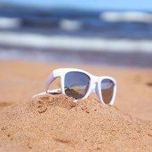 Load image into Gallery viewer, White youth sunglasses in the sand at the beach