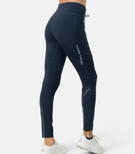 Load image into Gallery viewer, Back view of Anelie hiking tights that say Kari Traa in light blue