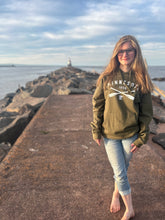 Load image into Gallery viewer, Minnesota cross paddle green hooded sweatshirt. Girl wearing it on pier