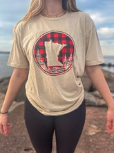 Load image into Gallery viewer, Woman wearing tan t-shirt with minnesota buffalo plaid design