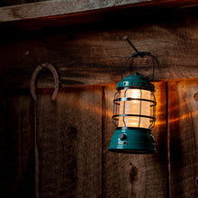 Load image into Gallery viewer, teal camping lantern hanging on nail