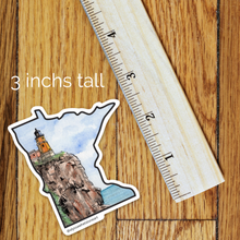 Load image into Gallery viewer, Watercolor sticker of Minnesota's Split Rock Lighthouse next to a ruler showing it is 3" tall