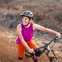 Load image into Gallery viewer, Woman on a mountain bike smiling with fuchsia tank top