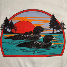 Load image into Gallery viewer, Loon graphic shows two loons and baby loon swimming in front of sunset scene