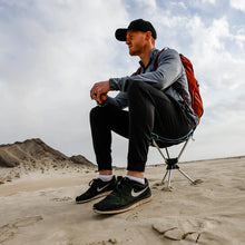 Load image into Gallery viewer, man sitting on the beach on a camp stool