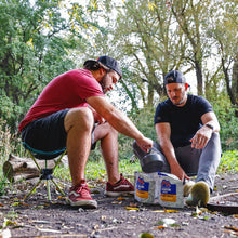 Load image into Gallery viewer, two men making camp coffee. One is sitting on a Grand Trunk camp stool