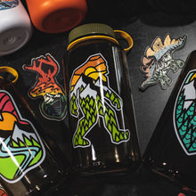 Load image into Gallery viewer, Nalgene water bottle with outdoor big foot design laying with some other stickers and water bottle