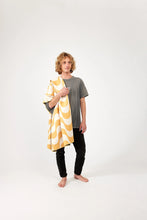 Load image into Gallery viewer, Man standing with yellow and white Nomadix towel