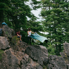Load image into Gallery viewer, Cascade fade blanket being held by women on top of rock