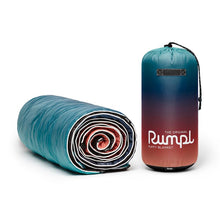 Load image into Gallery viewer, Puffy blanket is rolled up next to standing bag