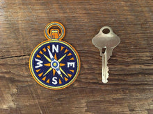 Load image into Gallery viewer, Compass patch next to a key for size reference

