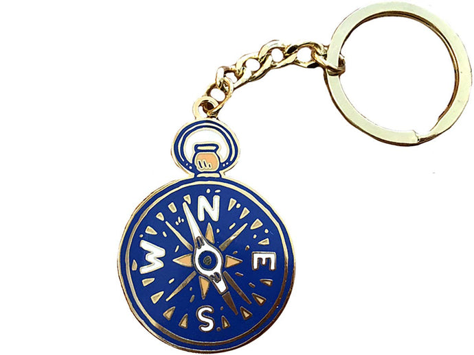 Blue and gold keychain featuring a compass