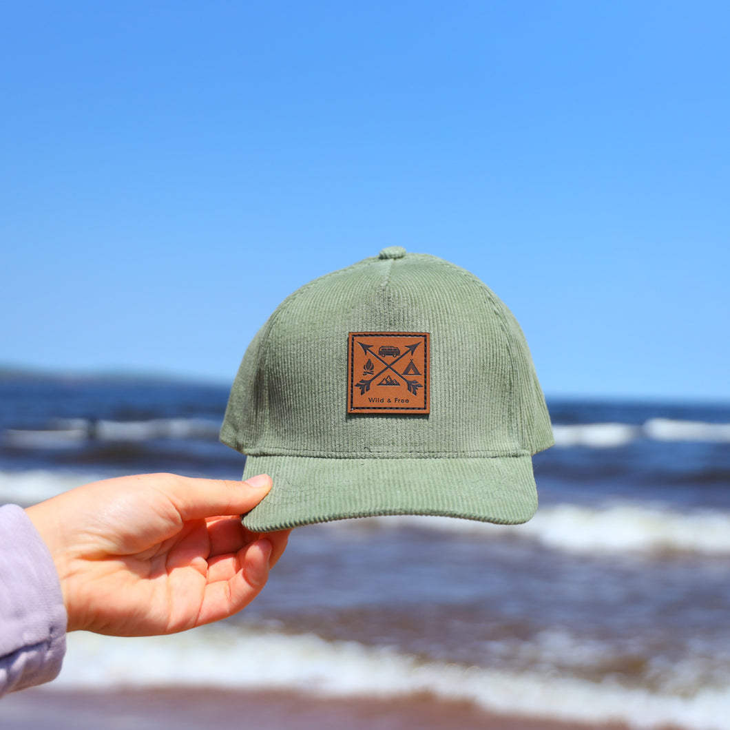 Green corduroy kids hat with leather cross arrow patch