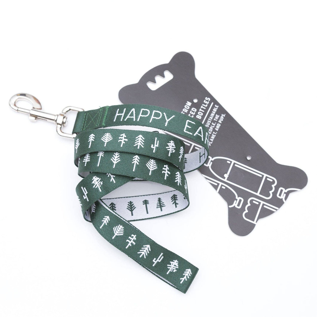 Dog leash that is green and white with trees