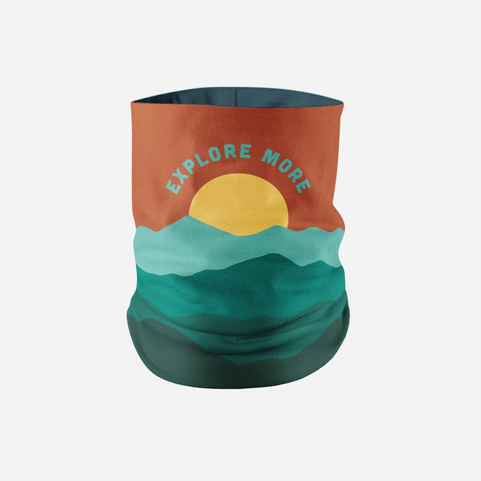 Neck gaiter that says explore more with a sun setting behind a hillside