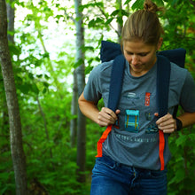 Load image into Gallery viewer, Girl hiking with trey t-shirt on that has hiking icons on it

