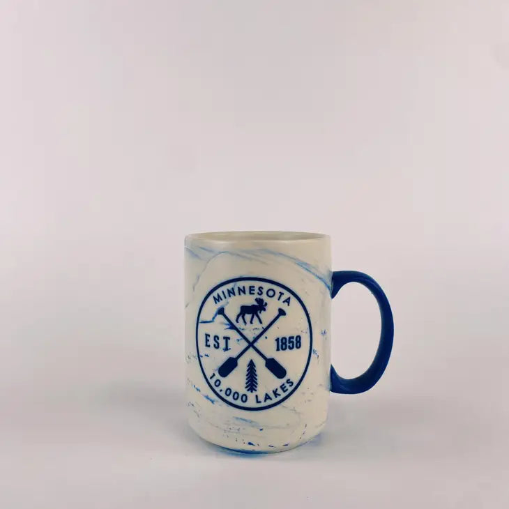 Minnesota marble mug with cross paddles that has a moose, est. 1858 and 10,000 lakes