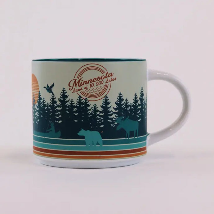 Mug that says minnesota land of 10,000 lakes with trees, woodland animals and 4 colorful lines around base