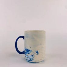 Load image into Gallery viewer, Back of marble mug with blue handle

