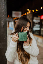 Load image into Gallery viewer, women smiling and holding a green mug with small evergreen wrap design on it
