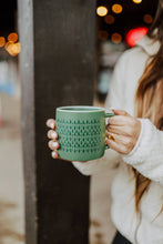 Load image into Gallery viewer, woman holding green mug with small trees printed all around it
