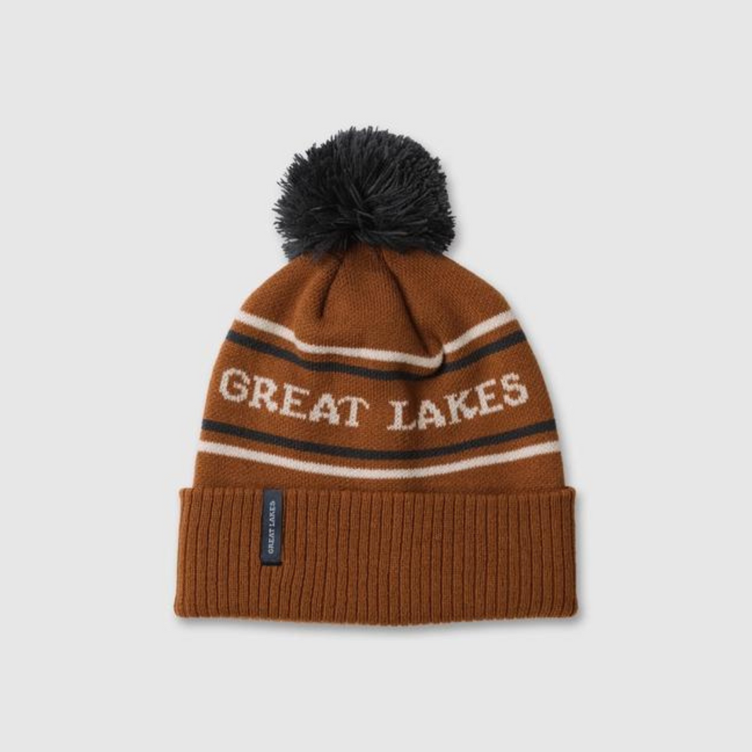 Beanie that is brown with blue pom that says Great Lakes