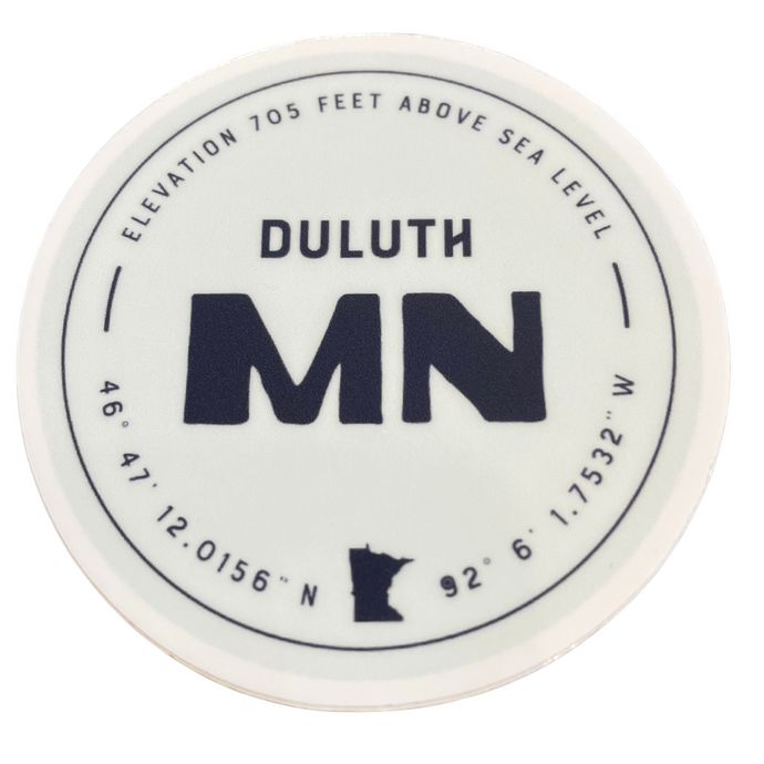 sea foam sticker with navy lettering that says Duluth, Minnesota with elevation and longitude and latitude of city