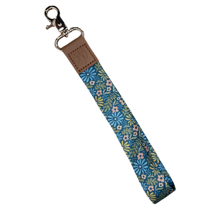 Blue wristlet on a keychain with pink, yellow, and green flowers