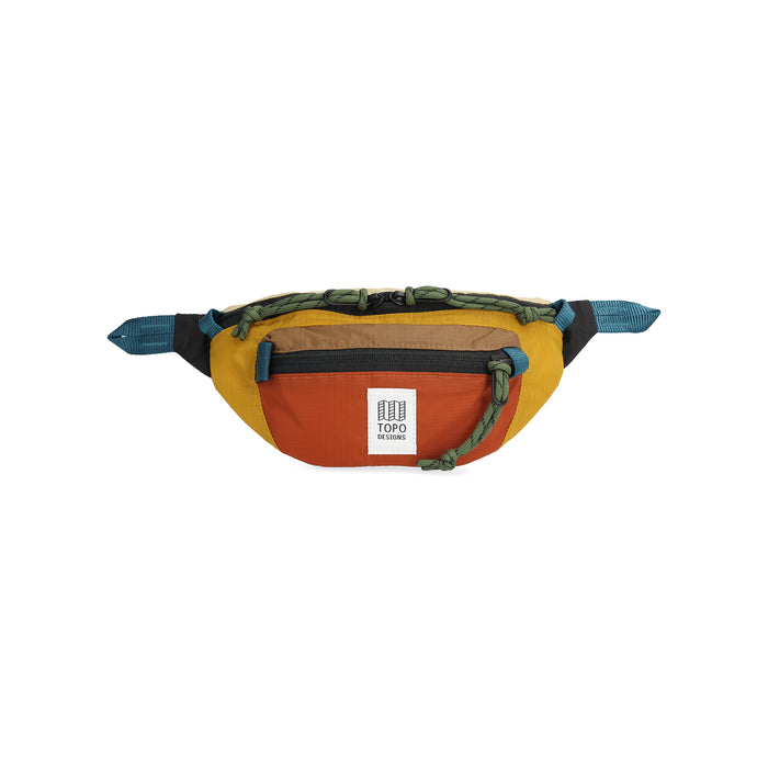 Fanny pack that is blue, mustard, and dark orange with green zipper handles