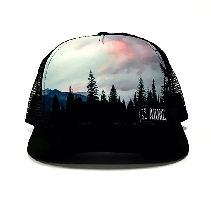 Black hat with black treeline and sunset clouds and hills behind the treeline