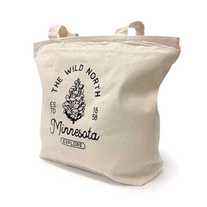 Zippered tote bag that says the wild north Minnesota explore with a pinecone in the middle