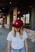 Load image into Gallery viewer, Woman wearing red hat with leather patch with three trees on it
