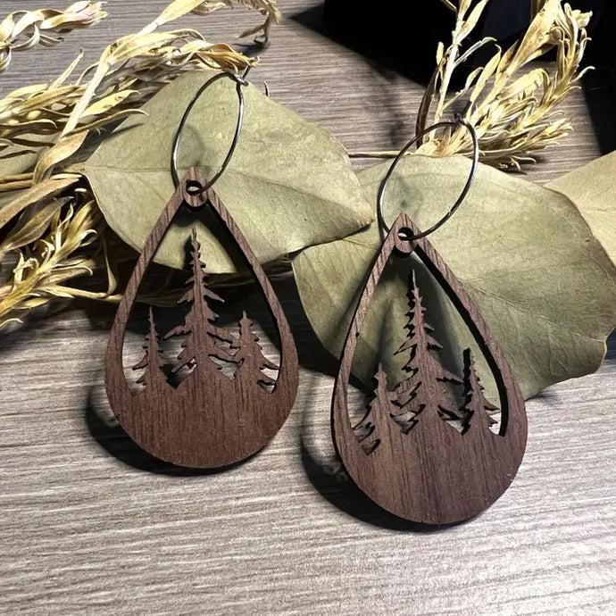 Dark wood teardrop earrings with three trees cut out of middle