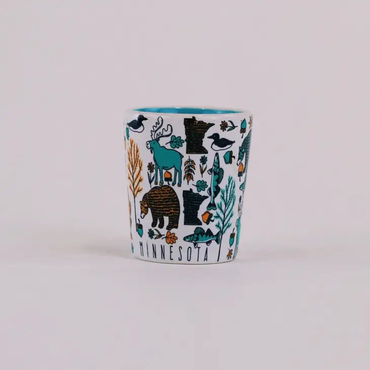 White minnesota shot glass covered in woodland animals