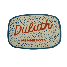 Load image into Gallery viewer, White sticker with orange script that says Duluth Minnesota with blue polka dots
