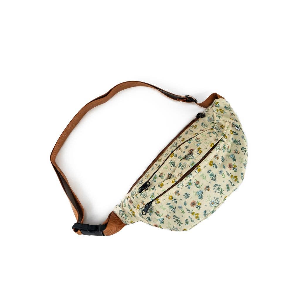 Wildflower fanny pack is cream with flowers all over it and brown belt