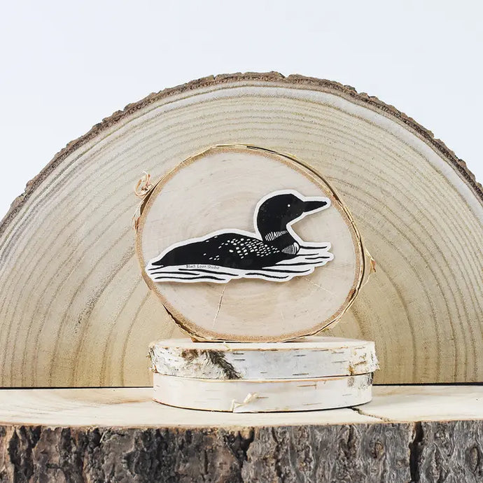 Black loon sticker swimming on wood cut-out