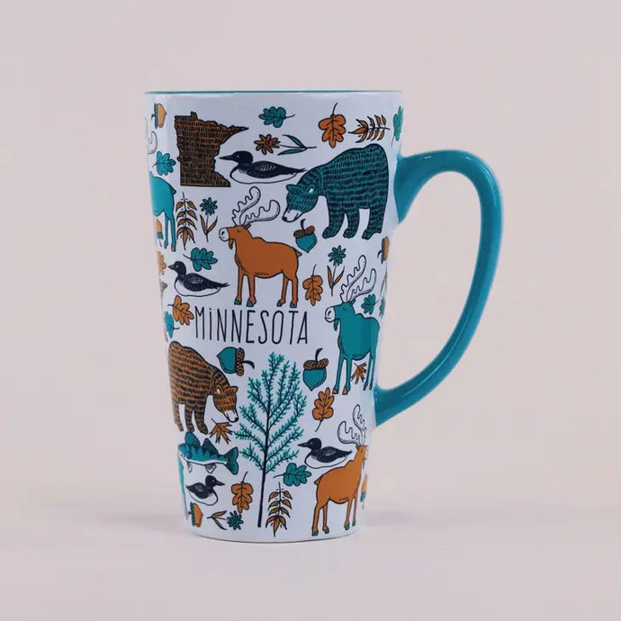 White mug covered with woodland animal design and blue handle