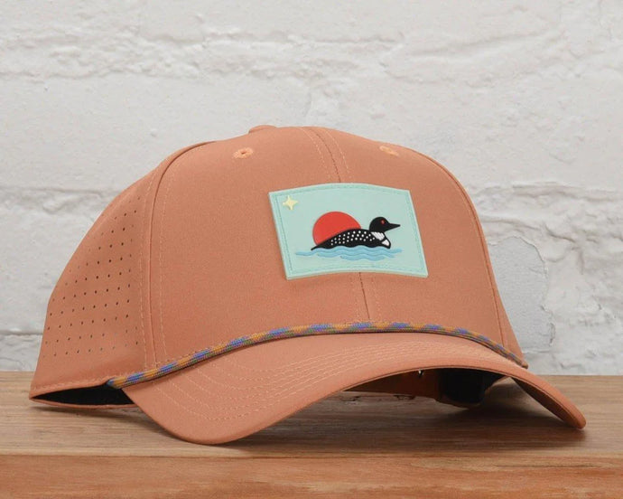 light orange hat with loon patch on the front and rope detail around the brim