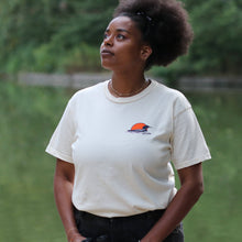 Load image into Gallery viewer, Woman wearing tan loon t-shirt. Has loon and sunset on front left side.
