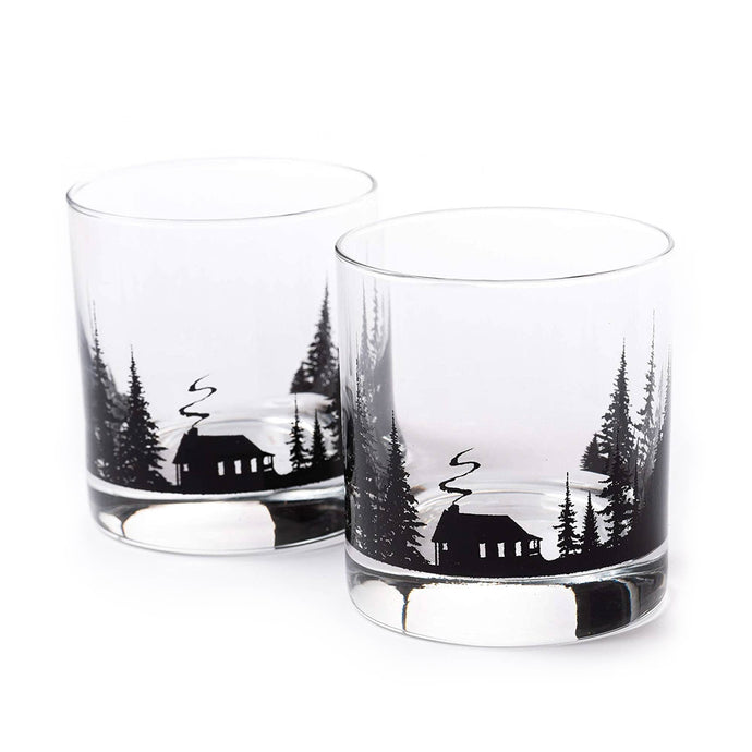 two whiskey glasses with cabin and trees etch