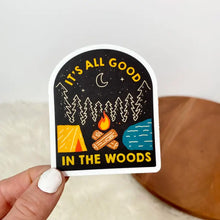 Load image into Gallery viewer, Sticker with woods, campfire, lake, and tent that says It&#39;s all good in the woods
