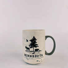 Load image into Gallery viewer, Marble swirl mug that has a moose, tree, and bear and says minnesota
