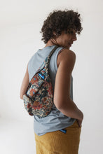 Load image into Gallery viewer, Person wearing a floral backpack against a plain background

