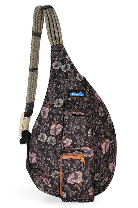 Kavu sling bag with dark background and pink and gray wildflowers