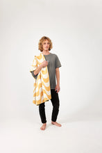 Load image into Gallery viewer, Man standing with yellow and white Nomadix towel
