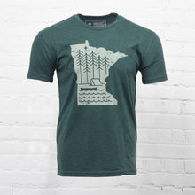 Load image into Gallery viewer, Green t-shirt with minnesota cut-out and trees, tent, and canoe on inside of state
