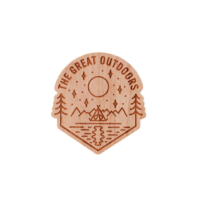 Wooden sticker that says the great outdoors with scene sketched in